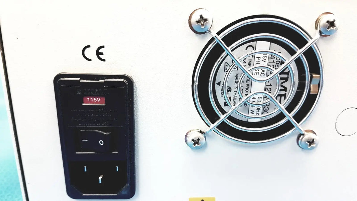 Black plastic power switch with 115v label and three-prong plug on back of Alltech 301 pump hplc laboratory chromatography unit next to silver fan grille