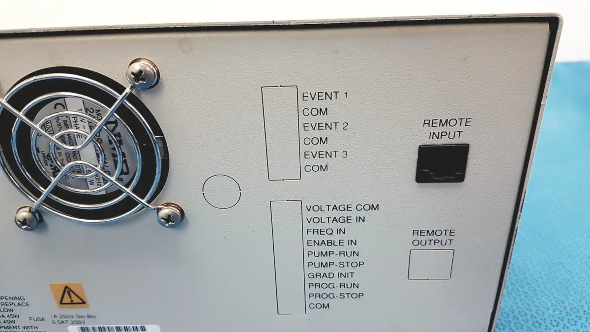 White alltech 301 pump hplc laboratory control panel with black labeled ports and circular fan on the left side back view