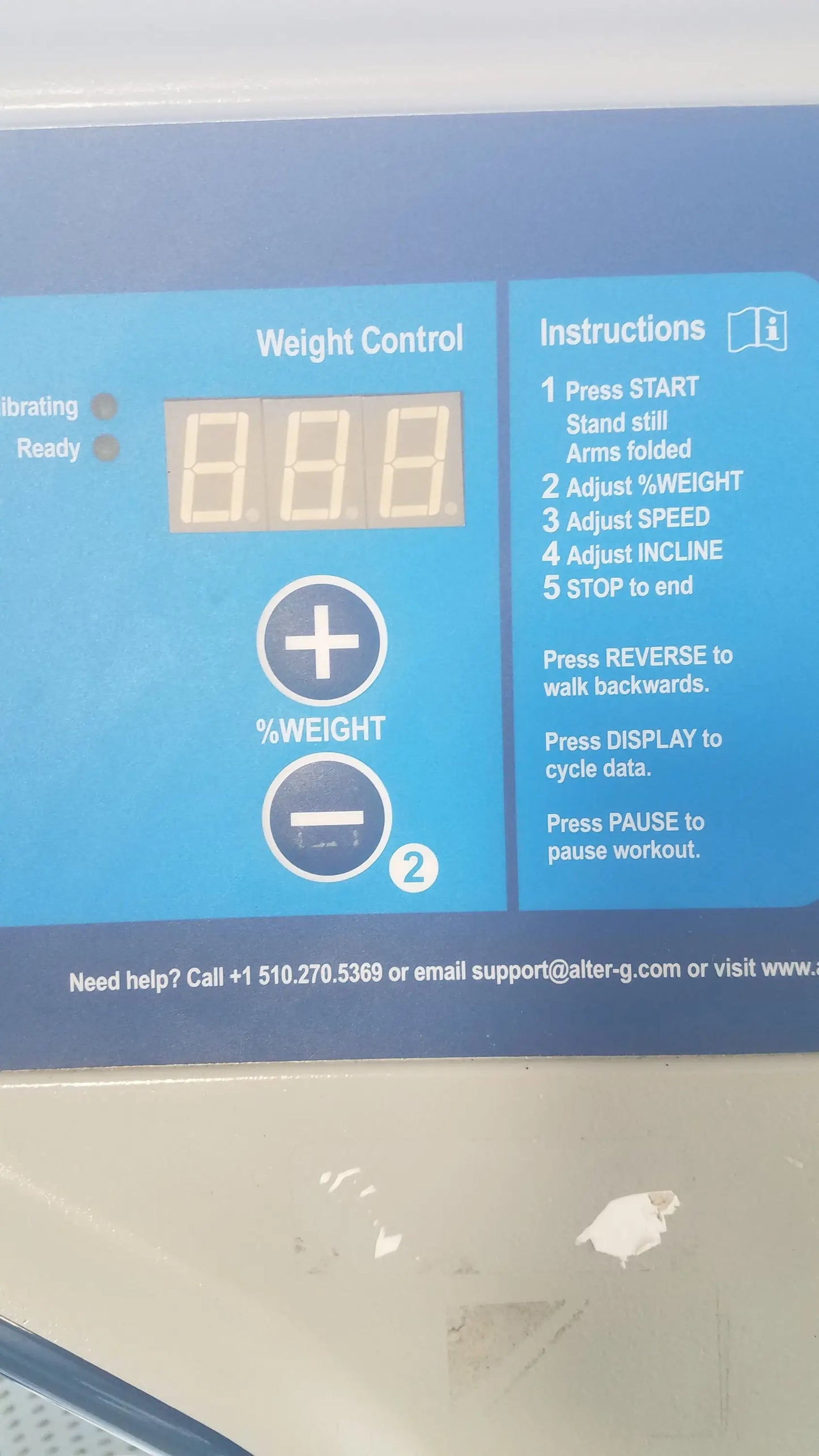 Blue digital weight control panel with illuminated display and buttons on alter g m320 anti-gravity treadmill with adjustable body-weight support