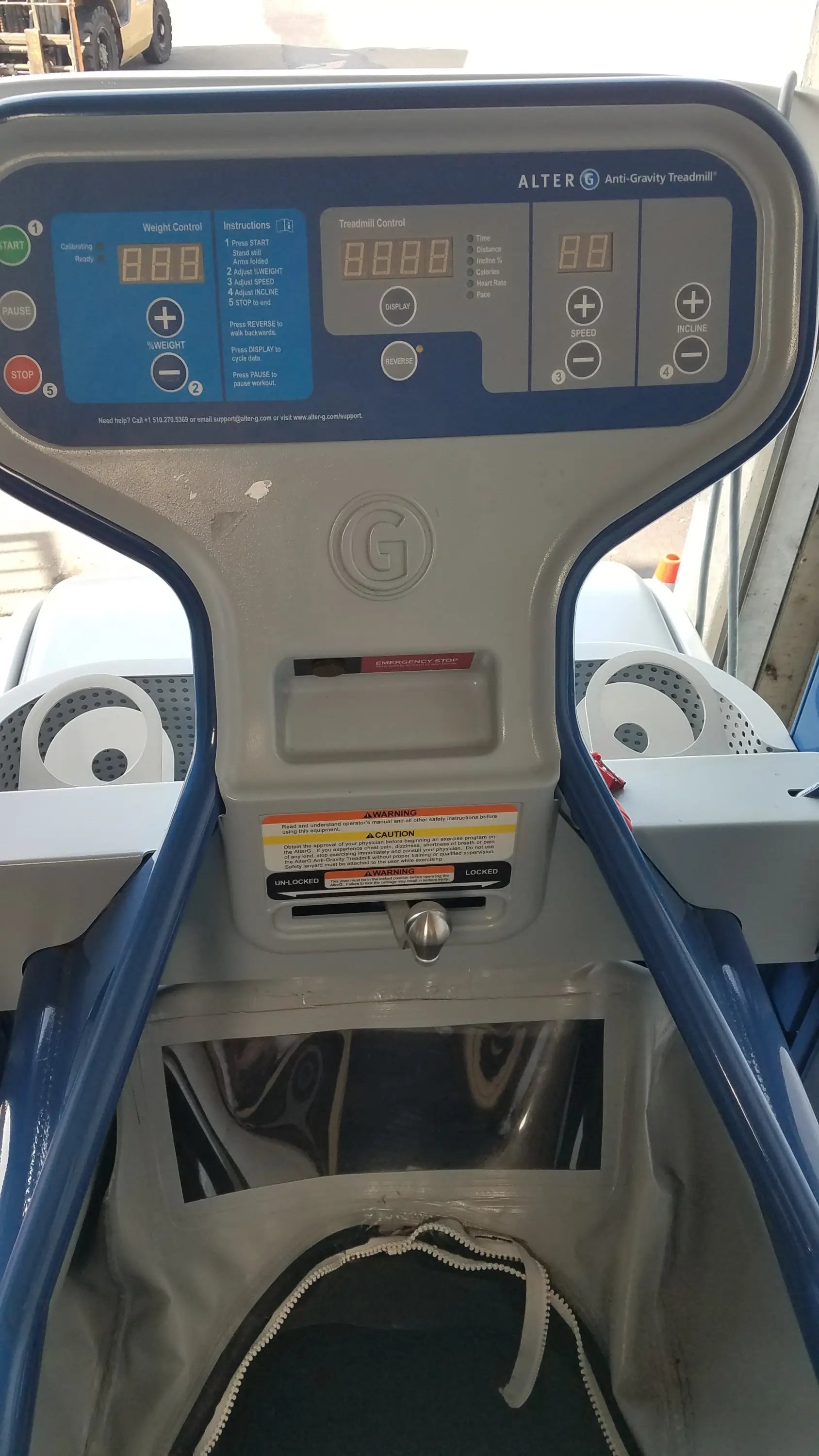 Blue and gray alter g m320 anti-gravity treadmill control panel with digital display and adjustable body-weight support