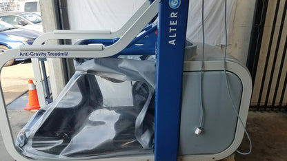 Blue and gray Alter G M320 anti-gravity treadmill with adjustable body-weight support and transparent protective cover
