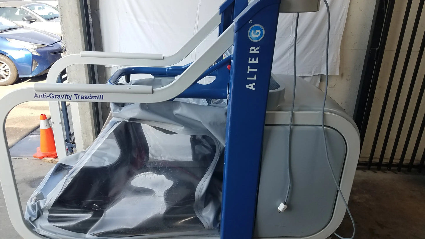 Blue and gray alter g m320 anti-gravity treadmill with adjustable body-weight support and transparent protective cover