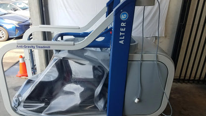 Blue and gray alter g m320 anti-gravity treadmill with adjustable body-weight support and transparent protective cover