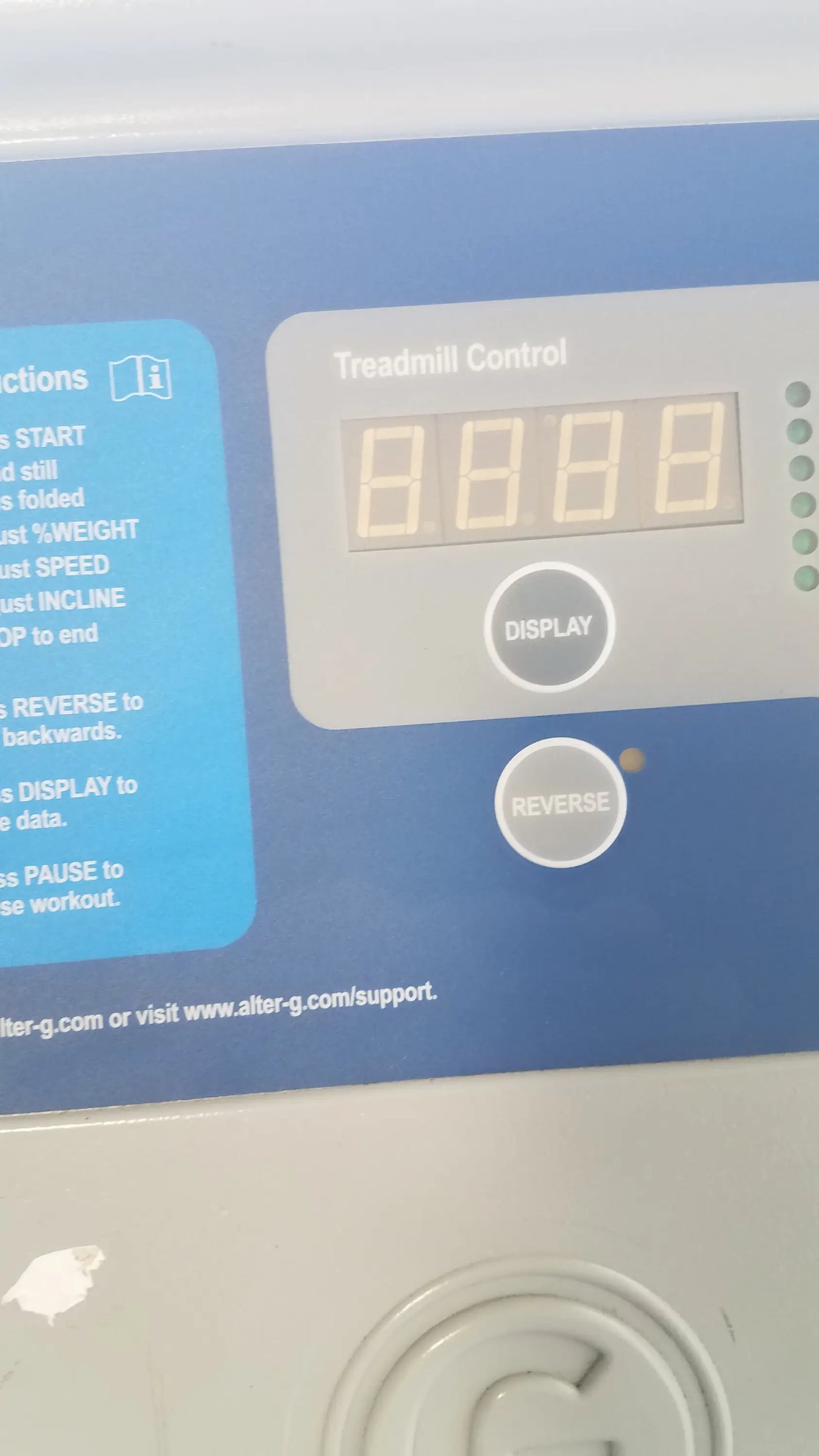 Blue and gray control panel of Alter G M320 anti-gravity treadmill with digital display and adjustable body-weight buttons