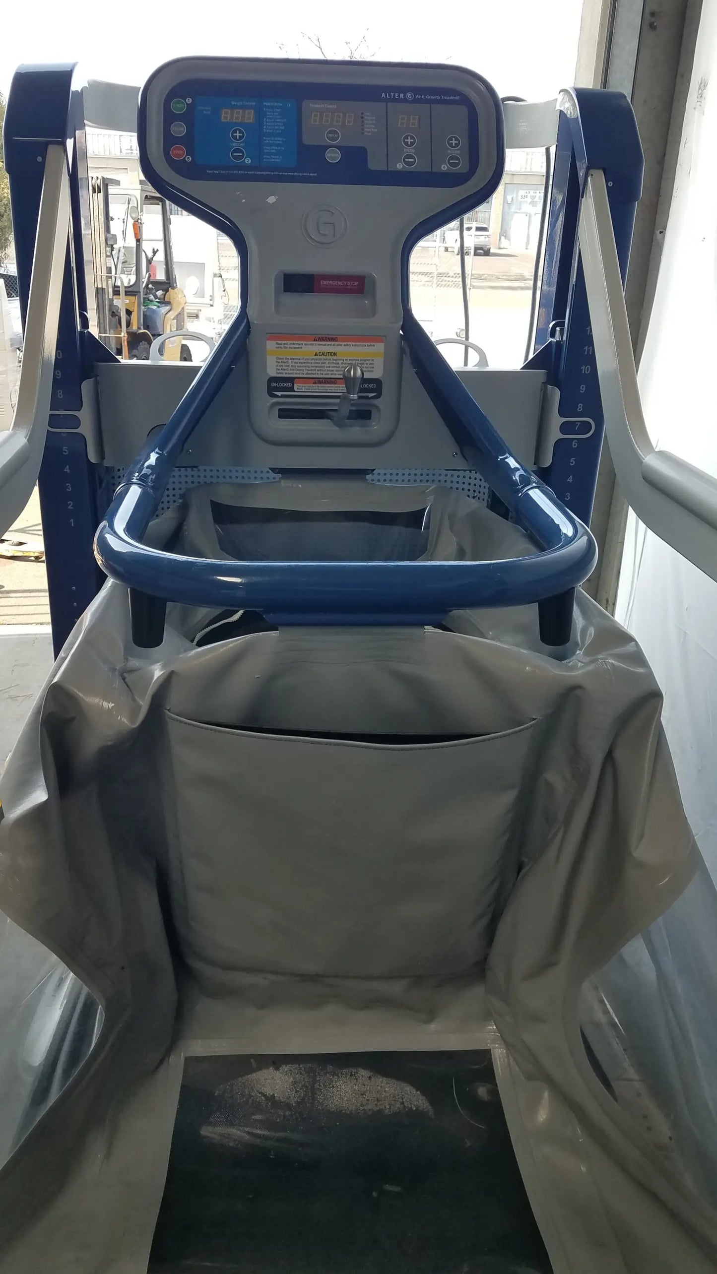 Alter g m320 anti-gravity treadmill in blue and gray with adjustable body-weight support and digital display panel