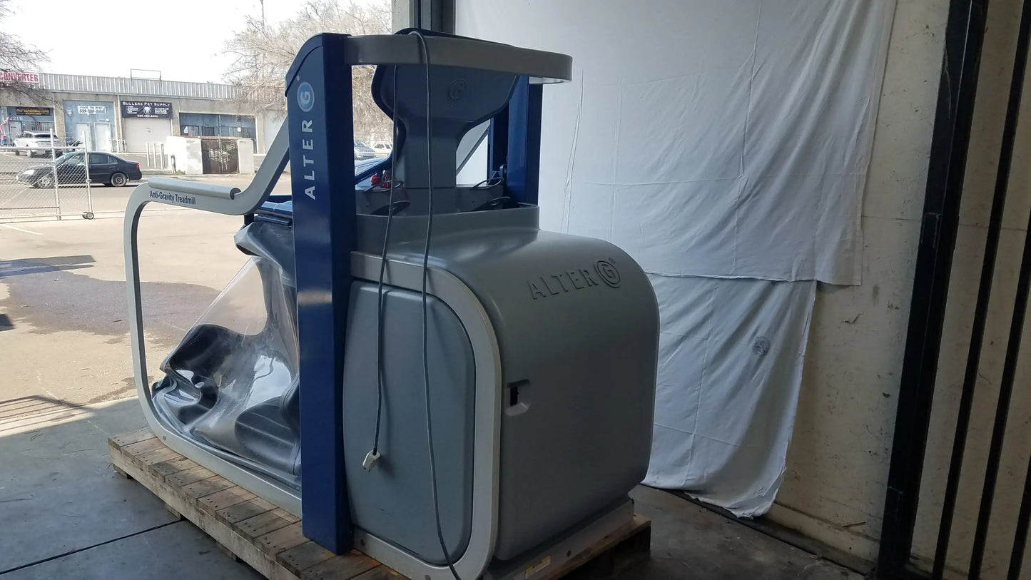 Alter G M320 anti-gravity treadmill in gray and blue with transparent protective cover and adjustable body-weight support
