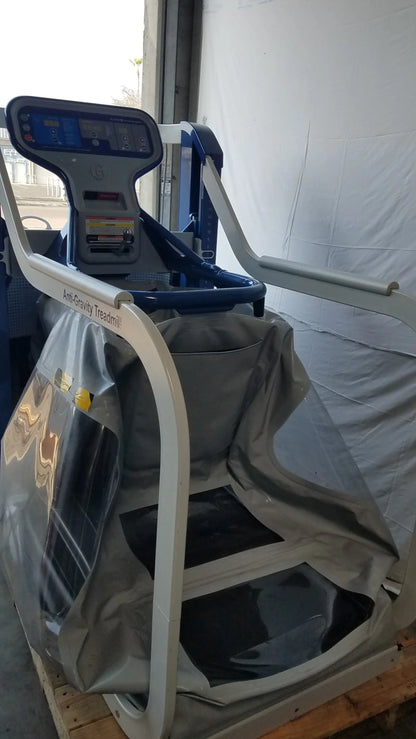 Alter G M320 anti-gravity treadmill gray and blue with digital display and padded handrails featuring adjustable body-weight support