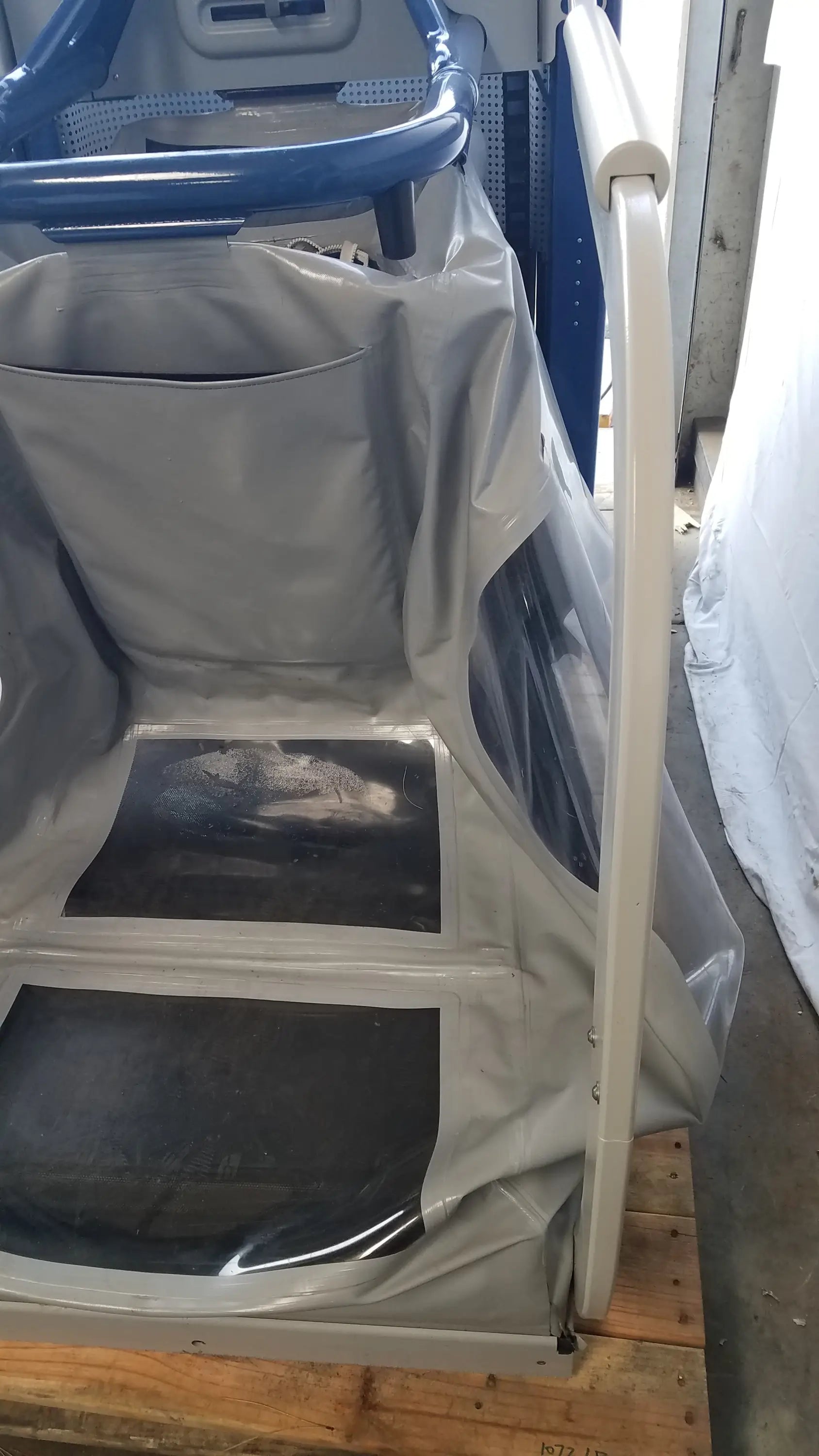 Alter g m320 anti-gravity treadmill with gray plastic cart featuring blue handlebars and adjustable body-weight support