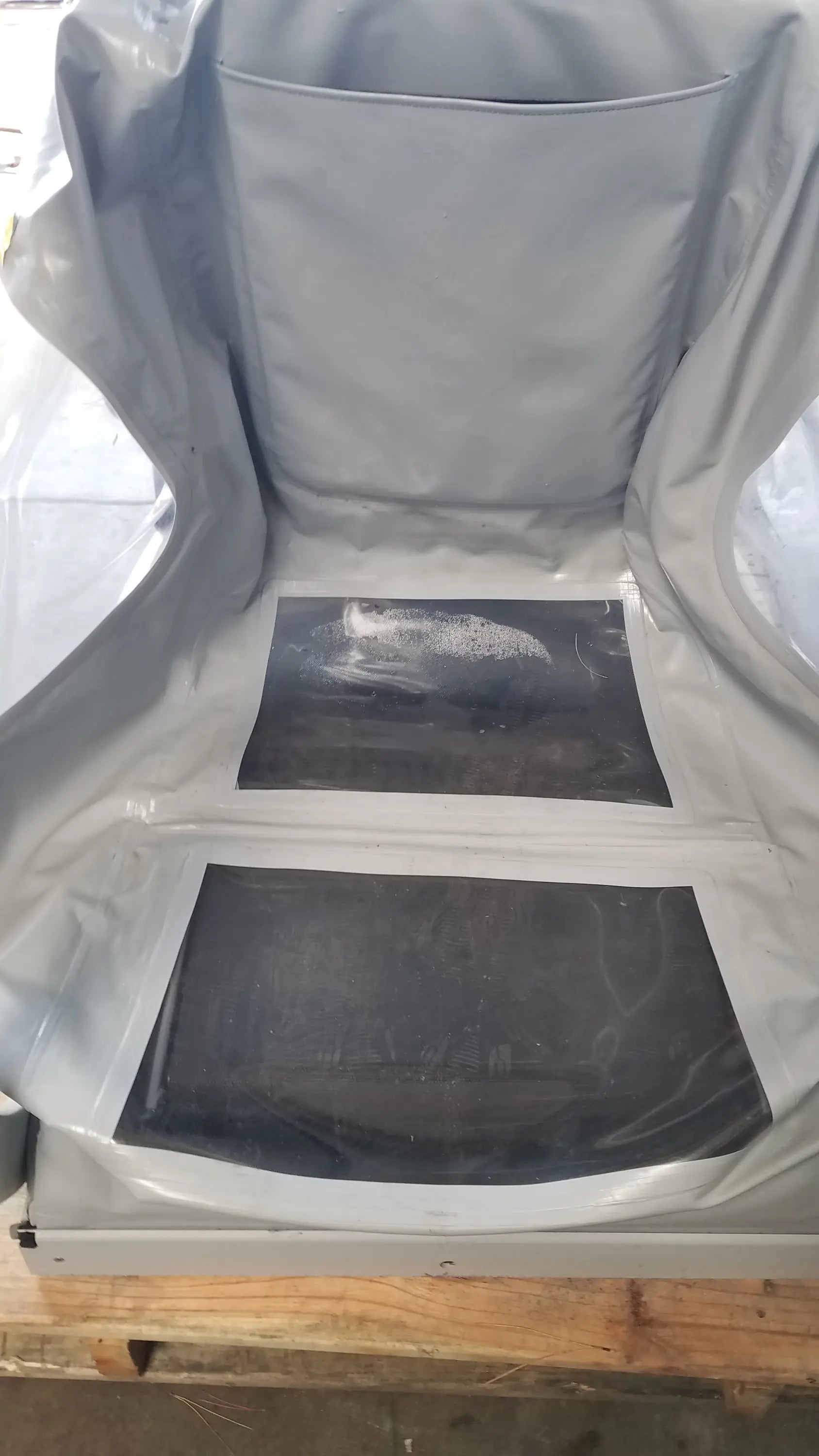 Gray protective cover with two black panels on the back of the Alter G M320 anti-gravity treadmill with adjustable body-weight support