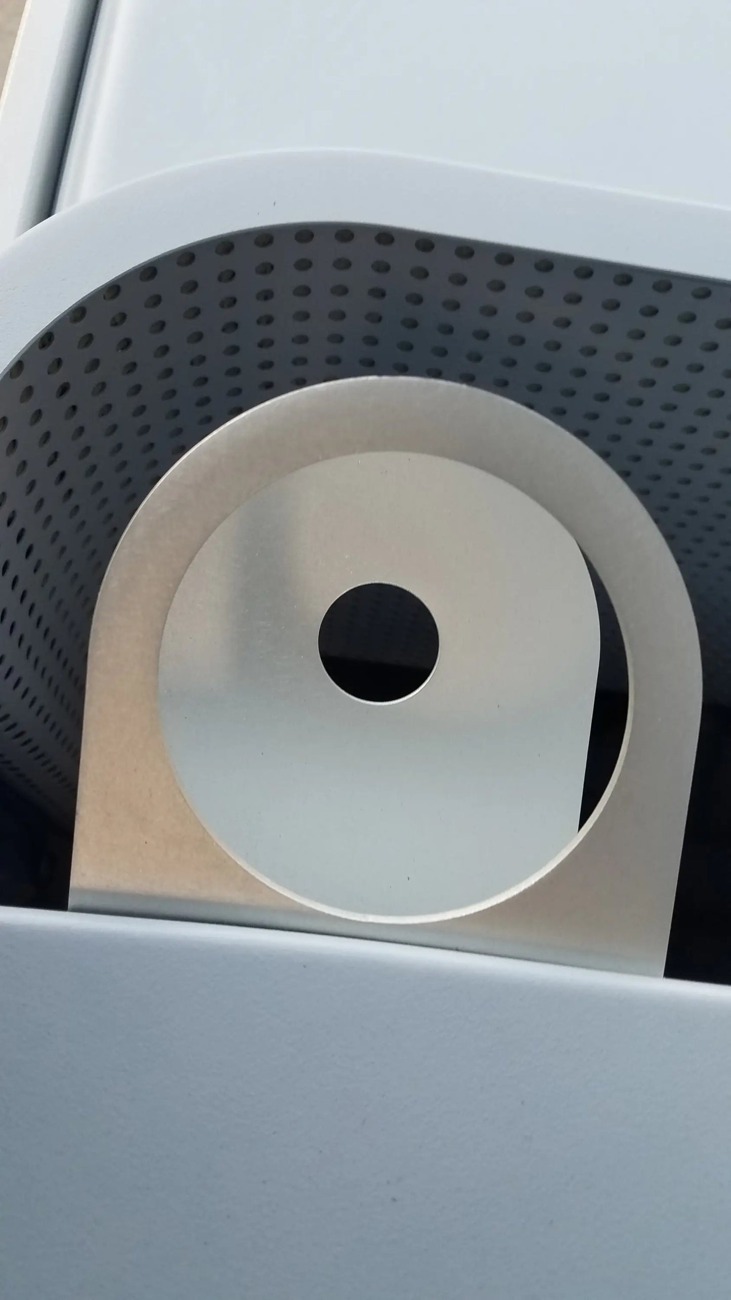 A sleek silver metallic circular component with central hole for the alter g m320 anti-gravity treadmill adjustable body-weight support