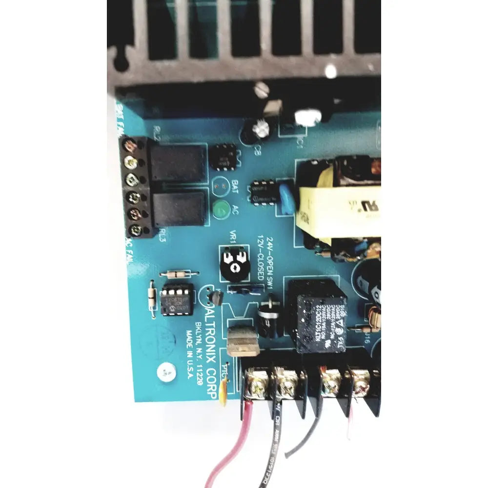 Blue altronix al400ulx power supply pcb with black components and labeled connectors for 12vdc or 24vdc output