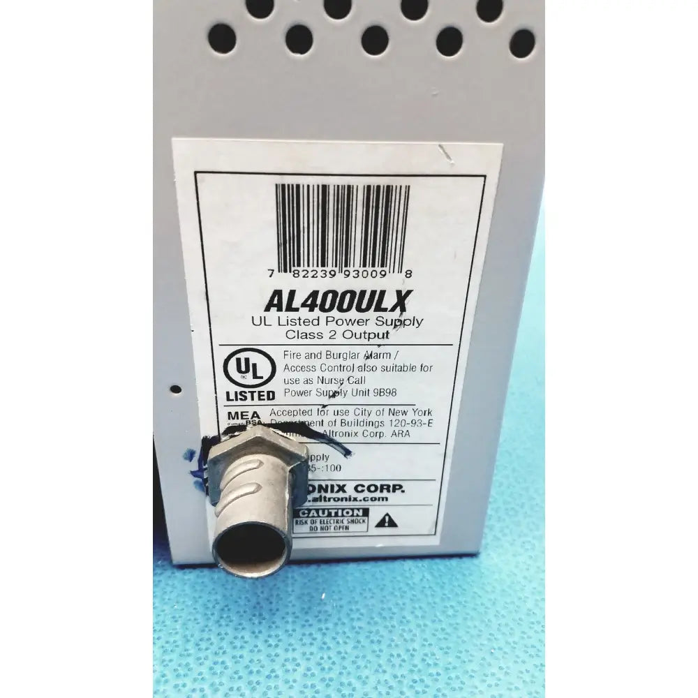 Gray metal altronix al400ulx power supply with threaded connector and white label for 12vdc or 24vdc use
