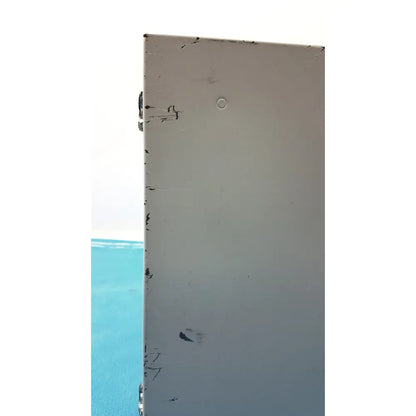 A weathered light gray metal panel with scratches and a small hole on the back of the altronix al400ulx power supply