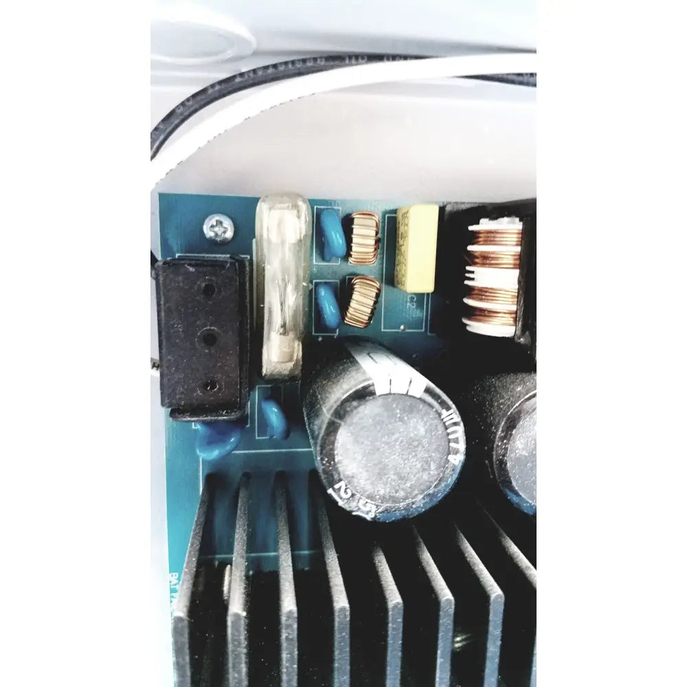Black cylindrical capacitor with silver metallic top and white labeling on altronix al400ulx power supply charger side