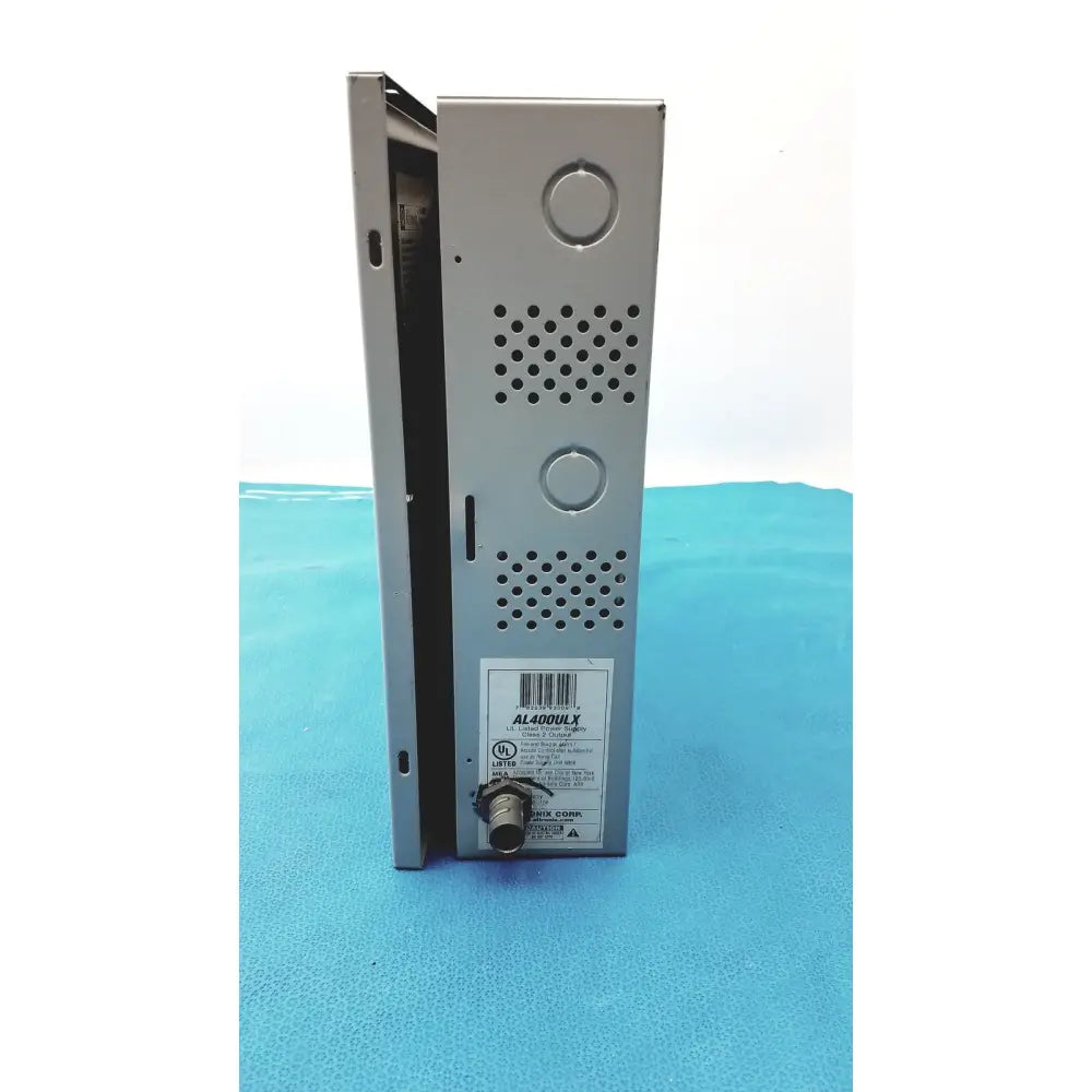 Silver metallic altronix al400ulx power supply with perforated ventilation panels and circular connector port visible