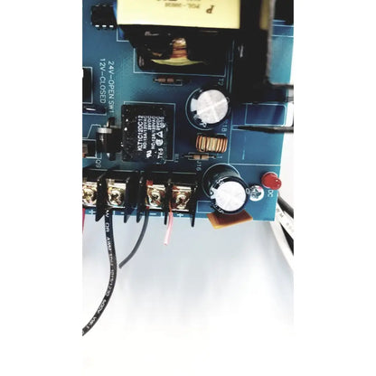 Blue circuit board of altronix al400ulx power supply with black silver components capacitors resistors and red button