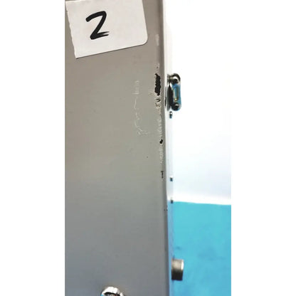 Gray metal cabinet of altronix smp5ctx high current power supply with small black latch and visible side scratches