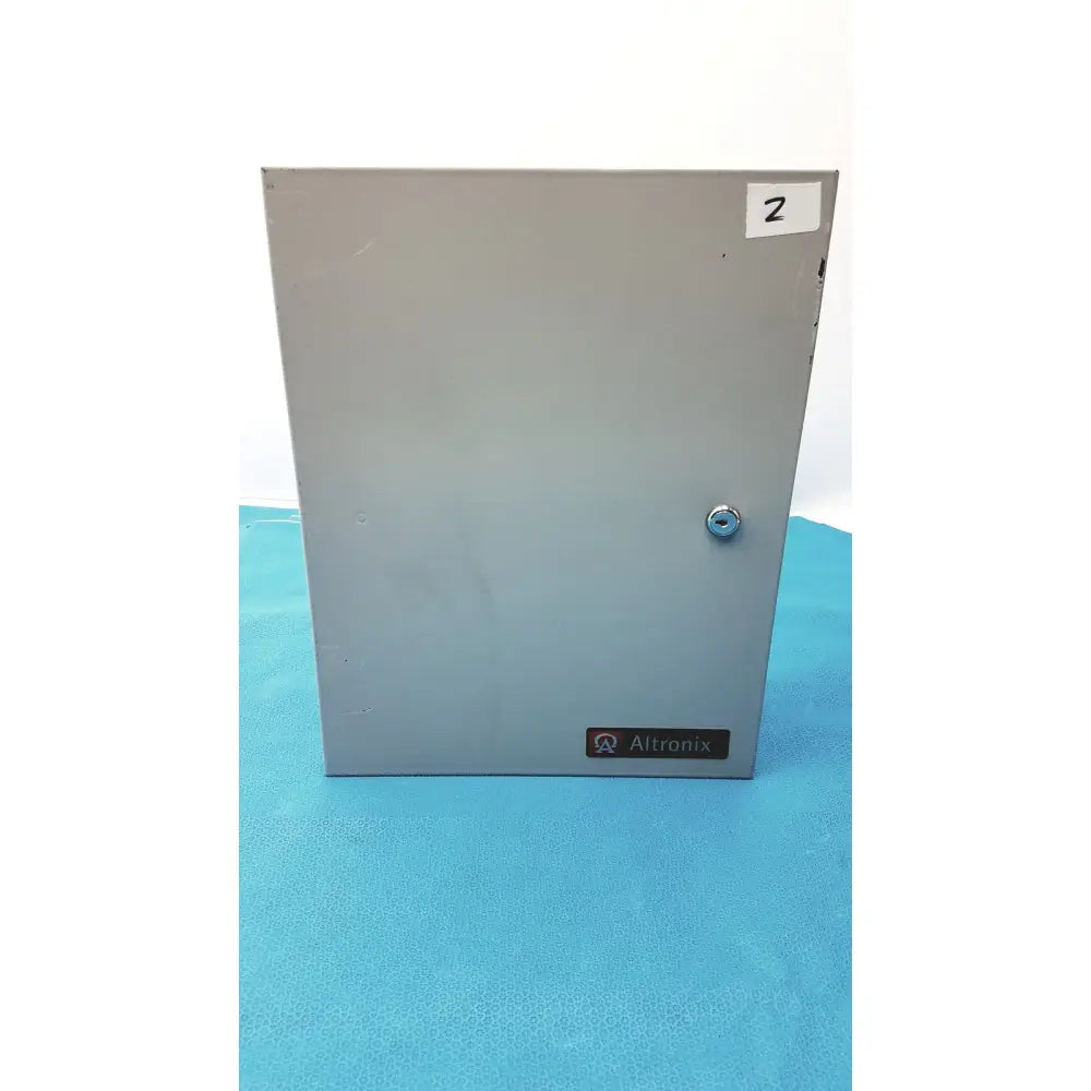 Gray metal electrical enclosure of altronix smp5ctx high current power supply charger with silver lock and altronix label