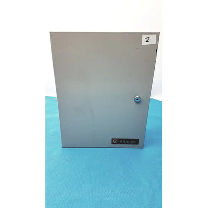 Gray metal electrical enclosure of altronix smp5ctx high current power supply charger with silver lock and altronix label