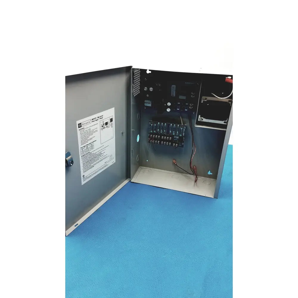 Gray metal electrical control panel of altronix smp5ctx high current power supply charger with visible wiring