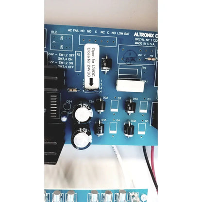 Blue altronix smp5ctx high current power supply circuit board with black and white electronic components visible