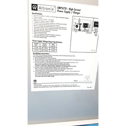Altronix smp5ctx high current power supply and charger with black plastic casing and silver metal terminals for 12vdc or 24vdc output