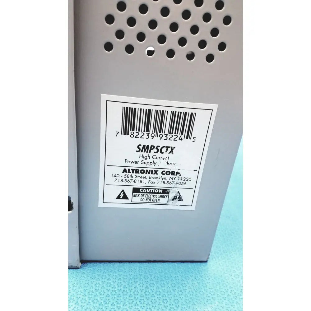 Gray metal altronix smp5ctx high current power supply with perforated ventilation and model number label smp5ctx