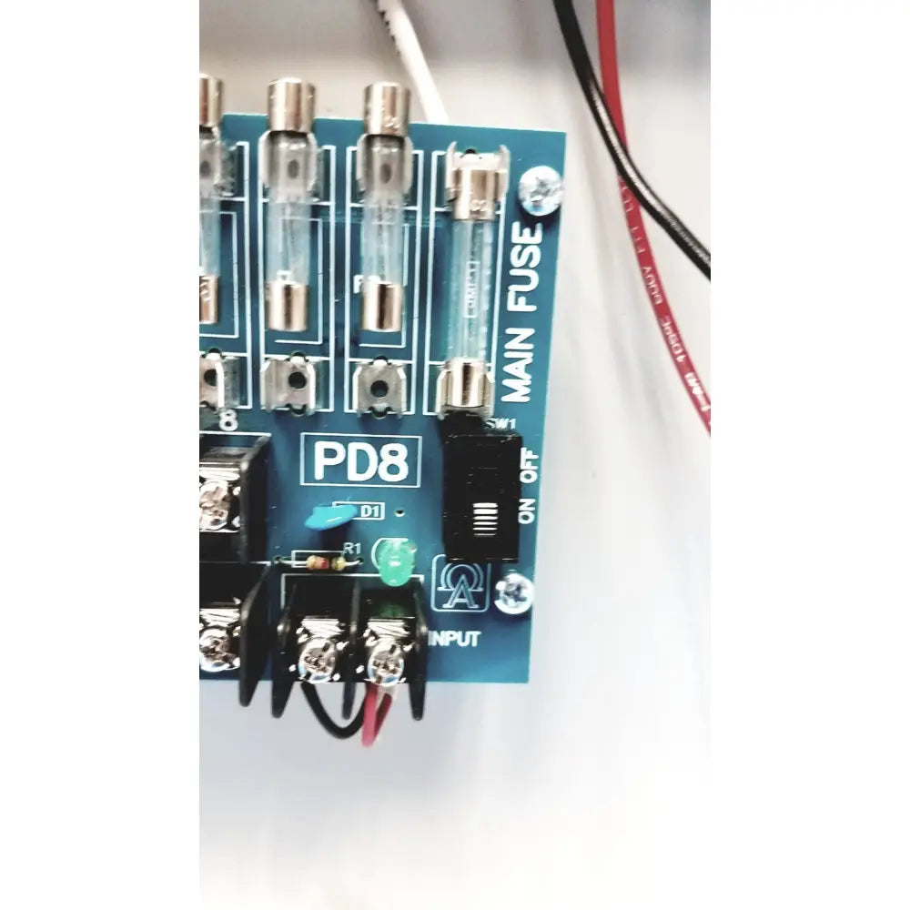 Blue circuit board of altronix smp5ctx high current power supply charger with eight glass fuses and on off switch