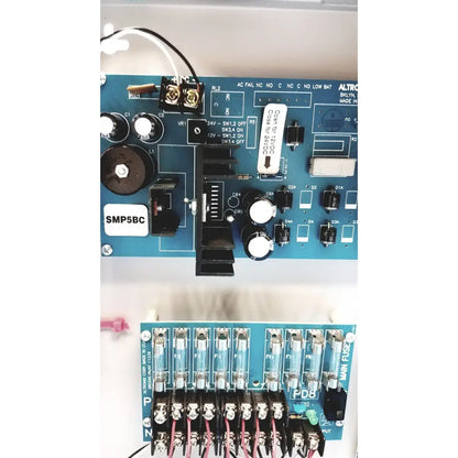 Blue circuit board with white labels and black components of altronix smp5ctx high current power supply charger