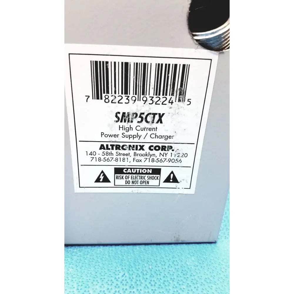 Gray plastic altronix smp5ctx high current power supply charger with white label and barcode for 12vdc 24vdc use