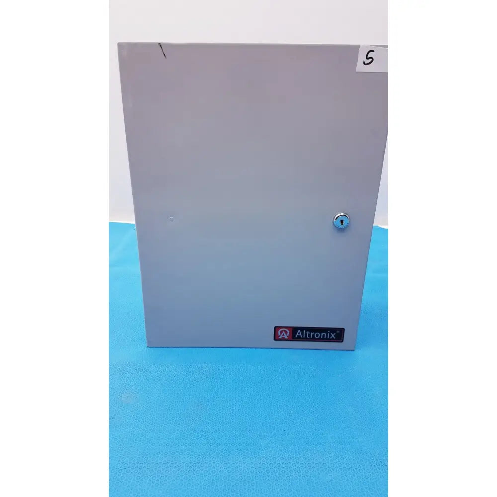 Gray metal altronix smp5ctx power supply enclosure with keyed lock and label for 12VDC or 24VDC use