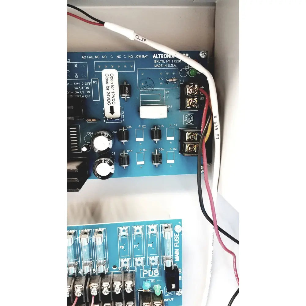 Blue altronix smp5ctx power supply panel with white labels and black components for 12vdc or 24vdc power charging