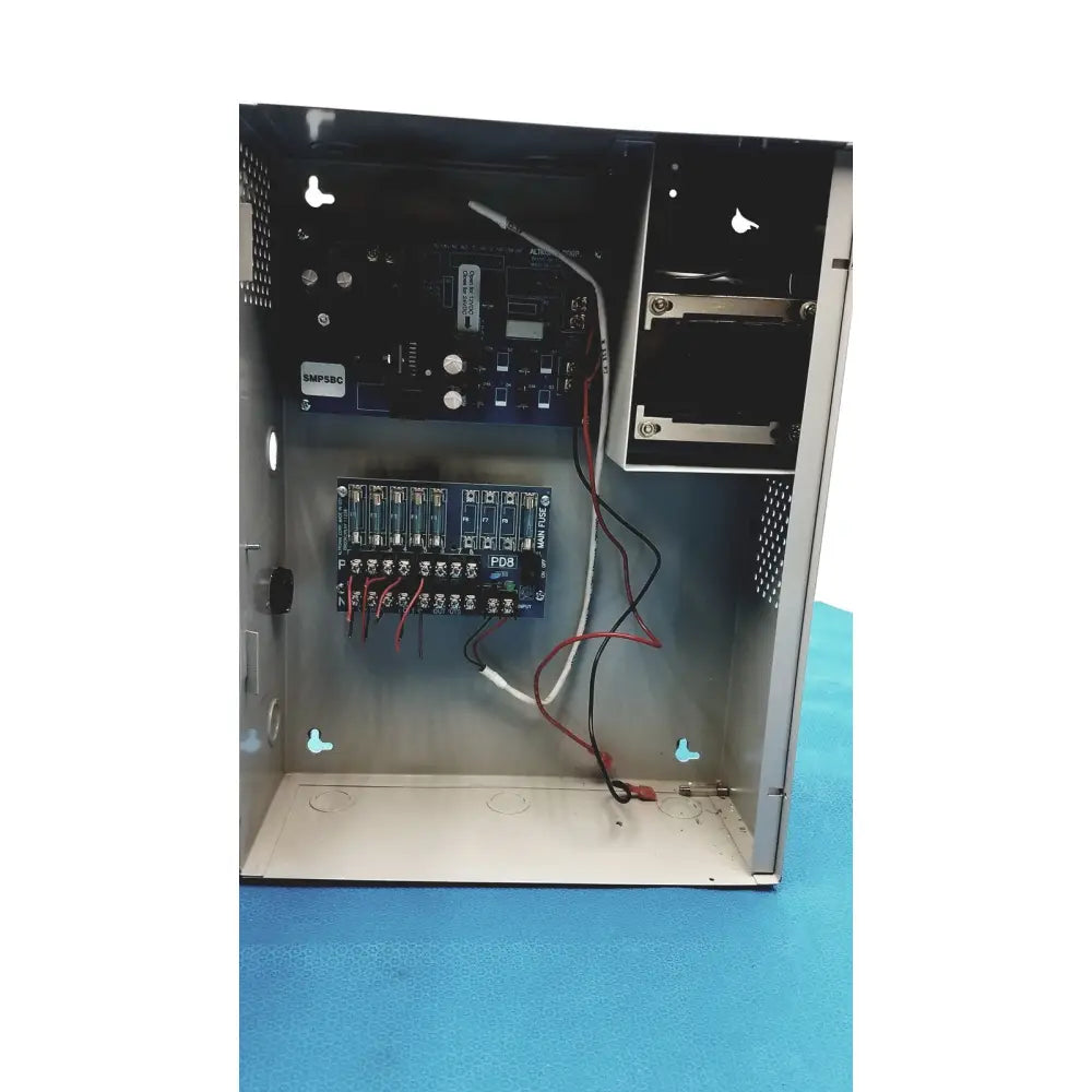 Black metal altronix smp5ctx power supply with visible internal circuit boards and wiring for 12vdc or 24vdc use
