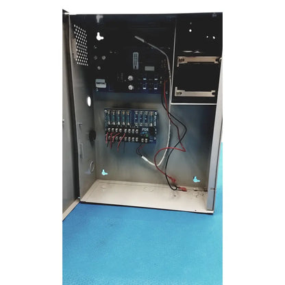 Metallic gray altronix smp5ctx power supply with blue circuit boards red and black wiring and white pdr label mounted inside