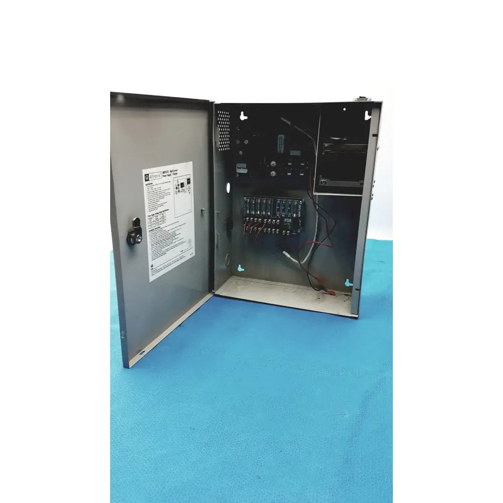 Gray metal electrical control panel with internal wiring and terminal blocks in altronix smp5ctx power supply charger