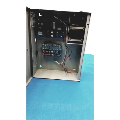 Metallic gray industrial control panel showing wiring and circuit boards inside for altronix smp5ctx power supply