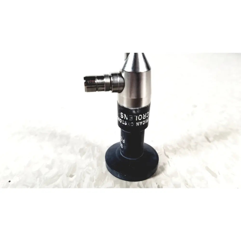 Silver and black microscope objective lens with engraved text from american cystoscope makers fo-8168m microlens barrel