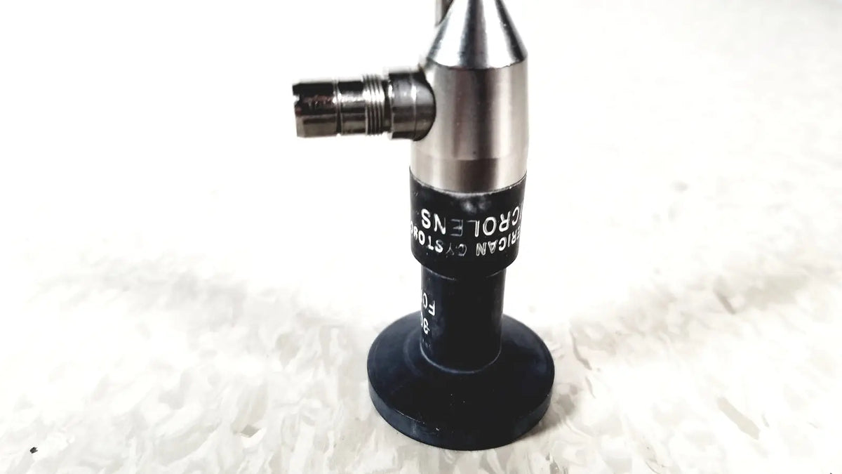 Silver and black microscope objective lens with engraved text from american cystoscope makers fo-8168m microlens barrel