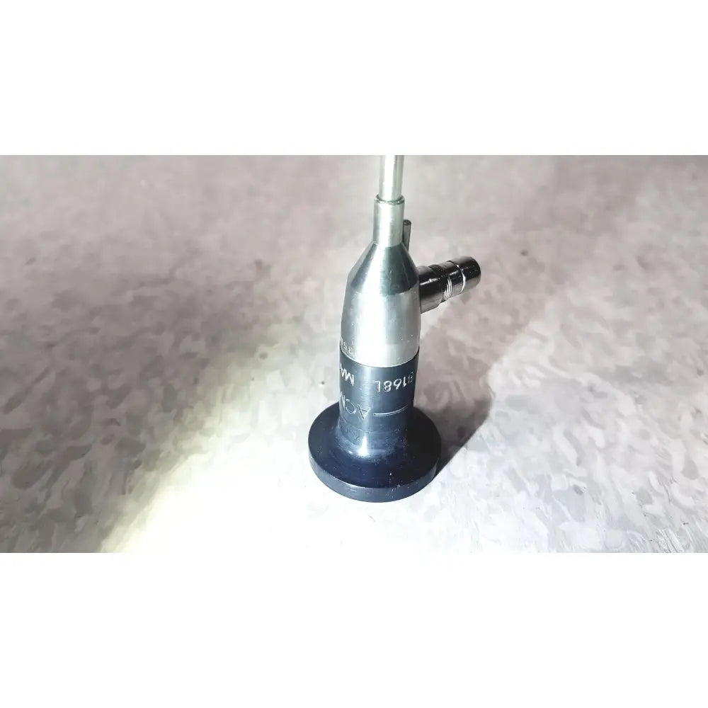 Silver and black medical-grade endoscope with cylindrical body and engraved markings by american cystoscope makers