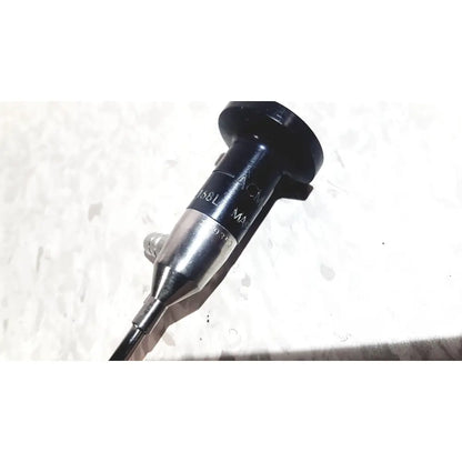 Black and silver medical endoscope with textured grip and engraved markings by american cystoscope makers inc