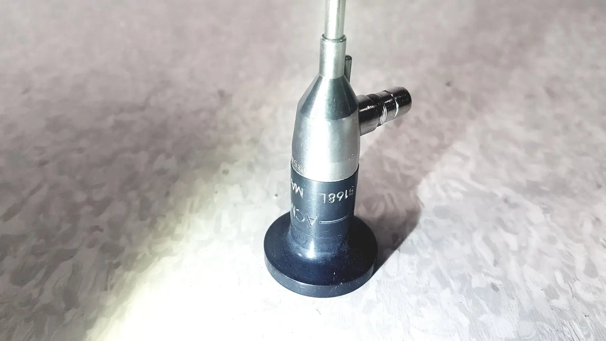 Silver and black medical-grade endoscope with cylindrical body and engraved markings by american cystoscope makers
