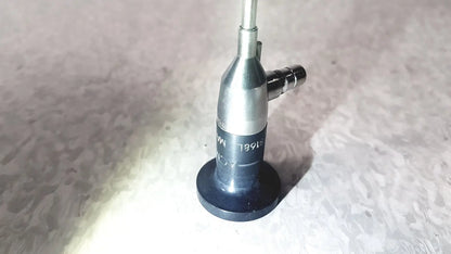 Silver and black medical-grade endoscope with cylindrical body and engraved markings by american cystoscope makers