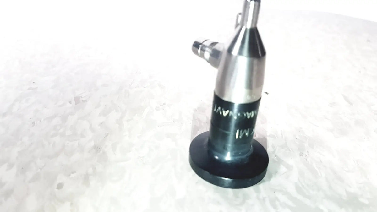 Silver metallic cylindrical microlens device with black base and threaded top by american cystoscope makers inc