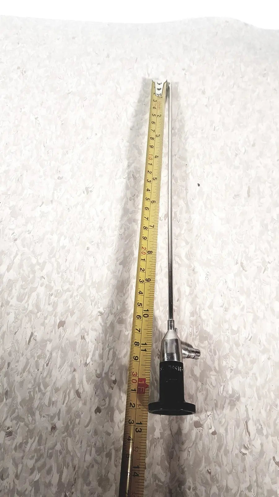 A slender metallic cystoscope with black handle and silver shaft by american cystoscope makers inc microlens fo-8168l