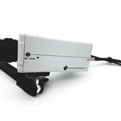 White rectangular american dynamics adcshr2412n bf lock camera mount with black hardware and attached cable back view