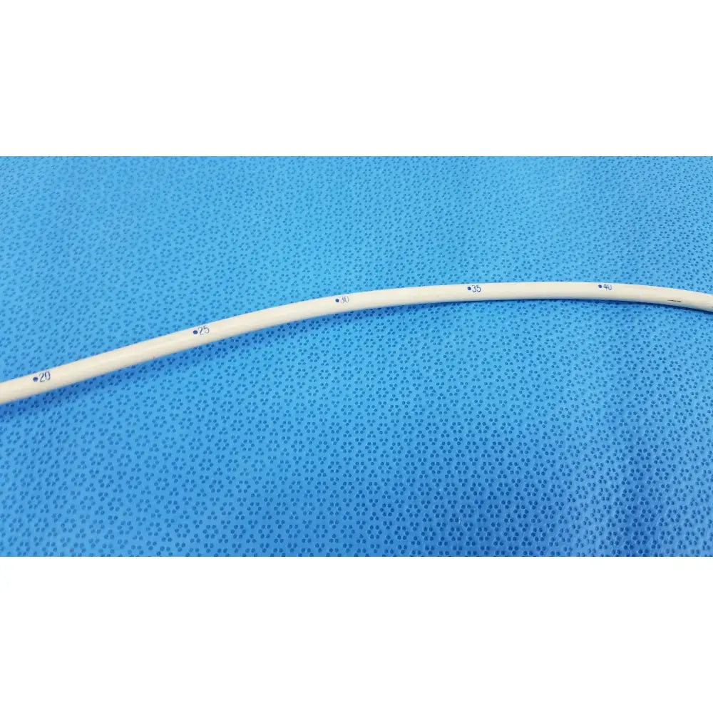 A white flexible tungsten-filled medical catheter with measurement markings in the American Endoscopy 18FR Maloney series