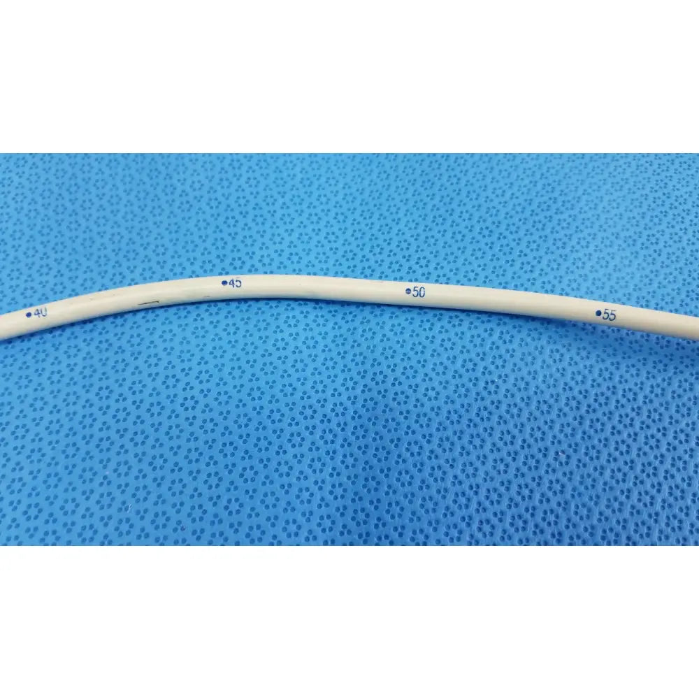 A beige flexible american endoscopy 18fr maloney tapered tungsten-filled esophageal bougie with blue measurement markings