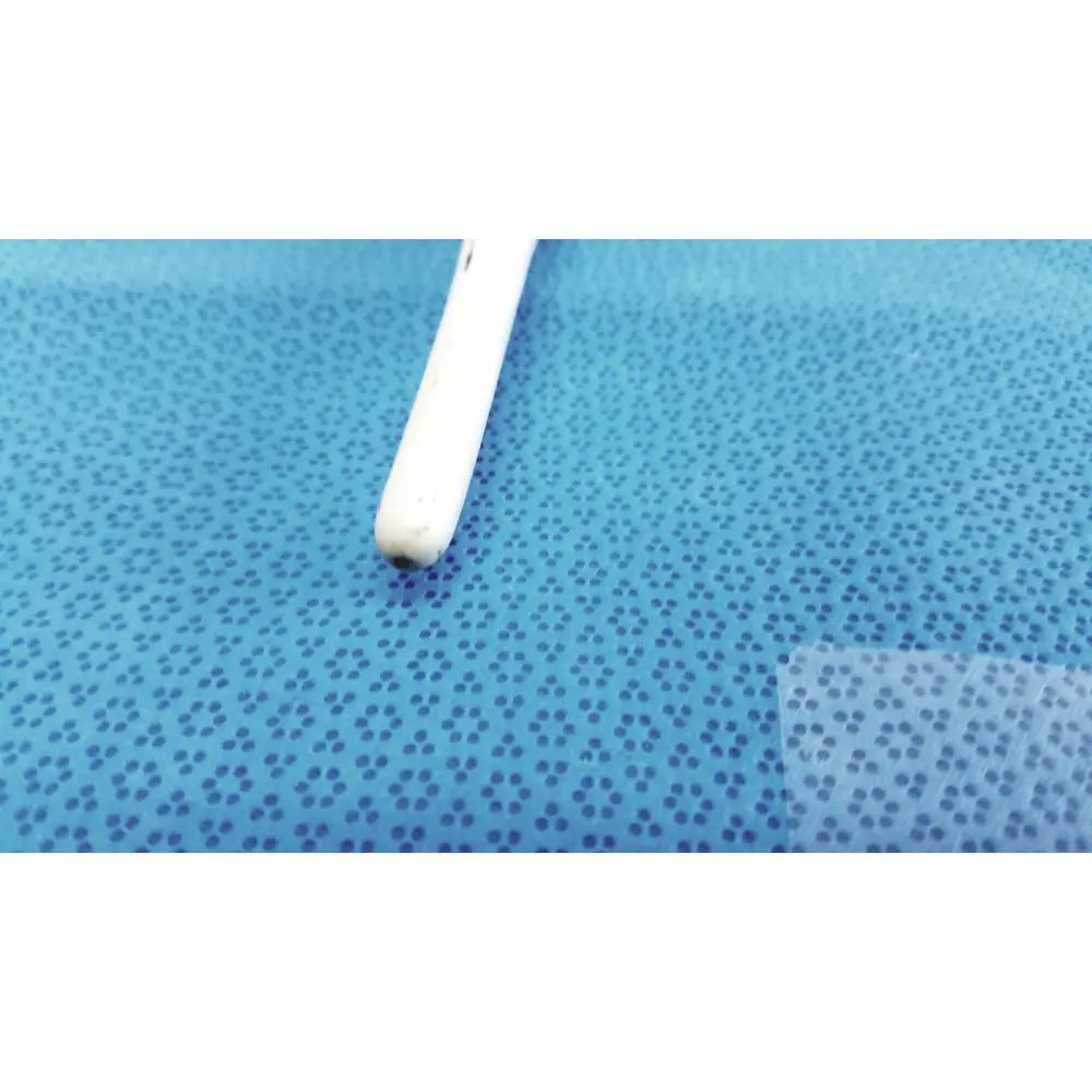 White plastic earbud with rounded tip resting on blue perforated surface beside american endoscopy 60fr maloney tapered esophageal bougie
