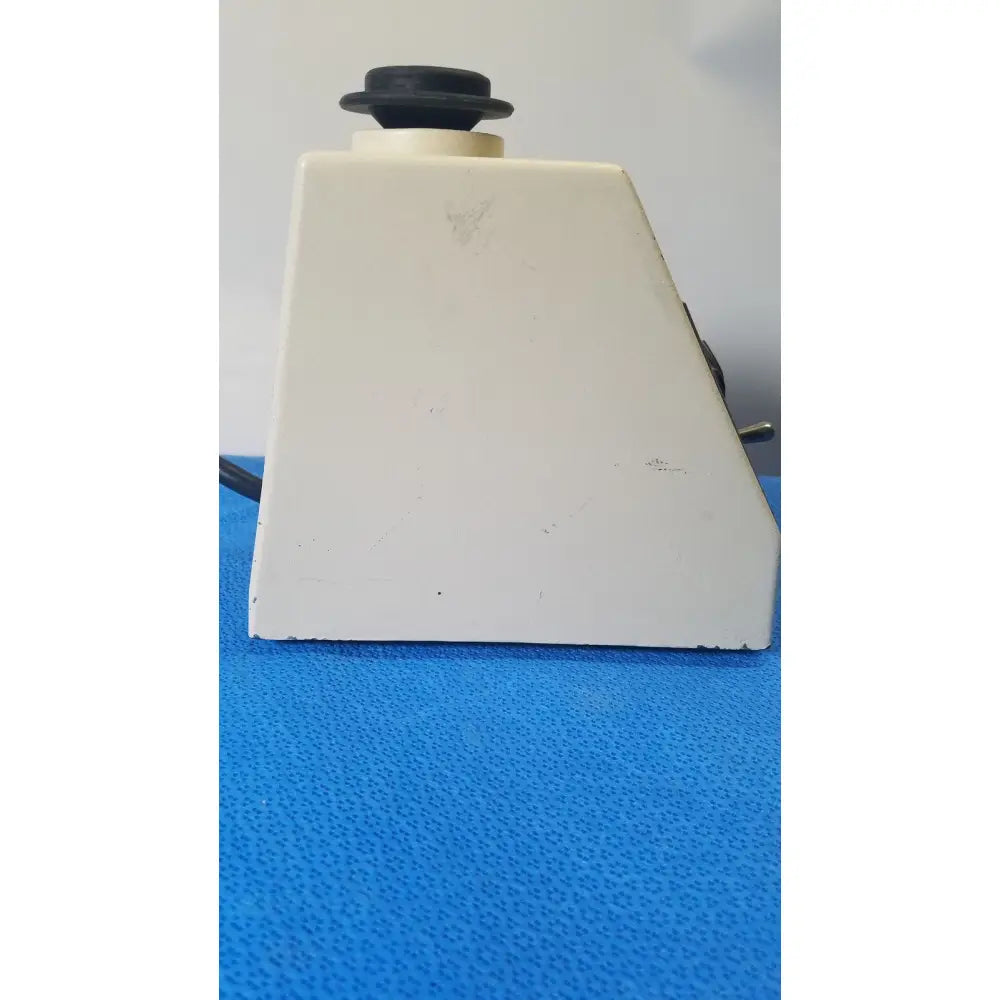 White plastic base with black circular knob of american scientific sp vortex mixer s8223-1 for laboratory use