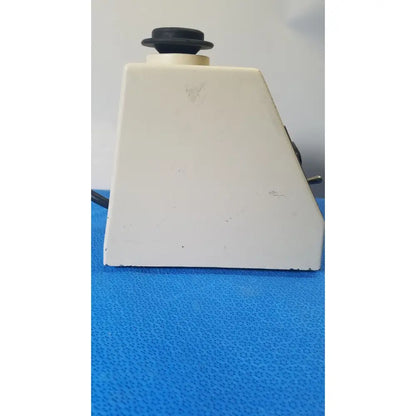 White plastic base with black circular knob of american scientific sp vortex mixer s8223-1 for laboratory use